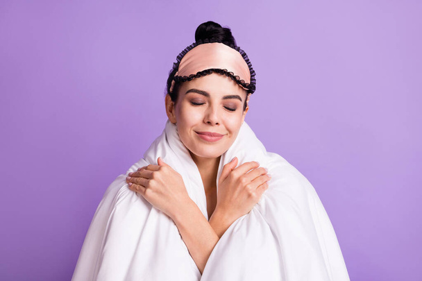 Photo of happy smiling positive dreamy young woman covered in blanket relaxing isolated on purple color background - Fotoğraf, Görsel