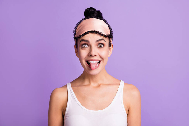 Photo of young beautiful smiling funky funny girl showing tongue fooling around isolated on violet color background - Φωτογραφία, εικόνα