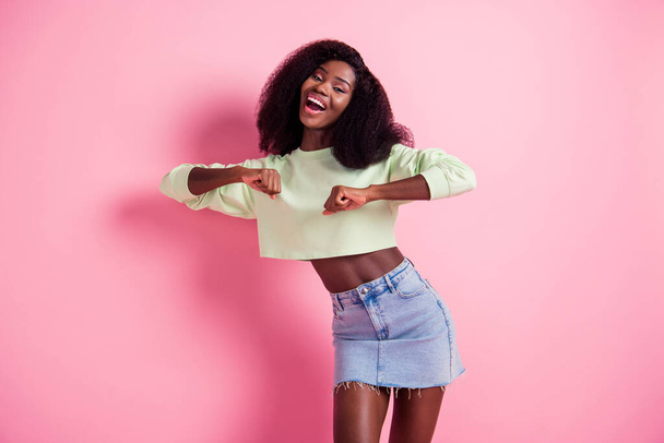 Portrait of cheerful pretty dark skin girl enjoy disco free time open mouth smile isolated on pink color background - Foto, immagini
