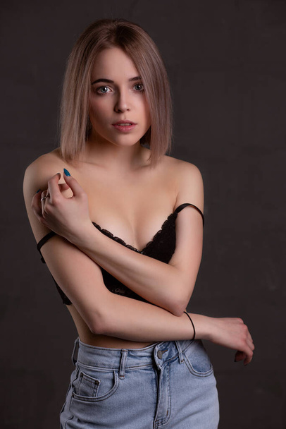 Gorgeous sexy girl in underwear posing in the studio on a black background. - Фото, зображення