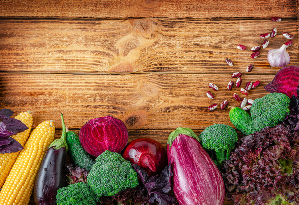 Border of colorful vegetables on wooden background. Organic food concept. - Photo, Image