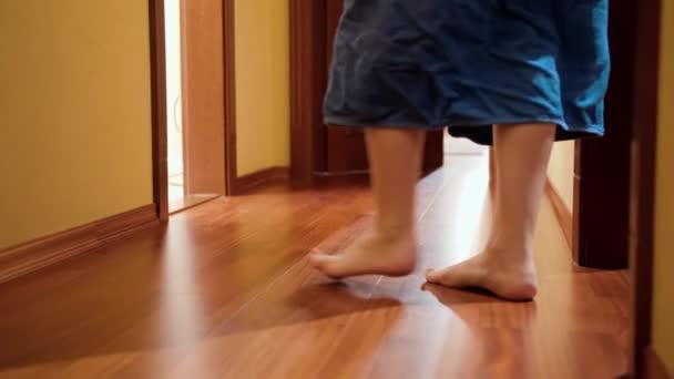 Barefoot family in towels and bathrobes entering bathroom at morning. Concept of family living in big house or on vacation - Footage, Video