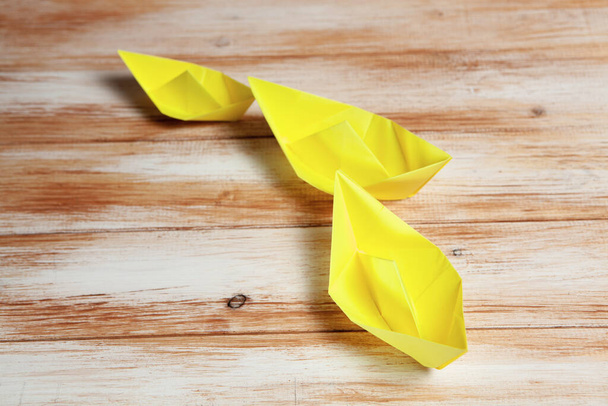 yellow paper boats on wooden background - Photo, Image