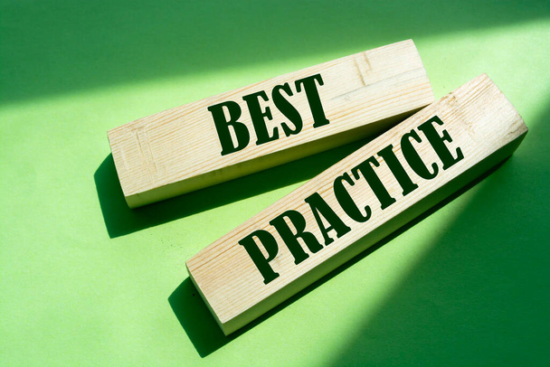 Best practice words in wooden blocks on green. Business or healthcare concept. - Foto, imagen