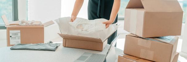 Packing clothing in mailing box for home shipping panoramic. Woman selling clothes online e-commerce business banner - Foto, immagini
