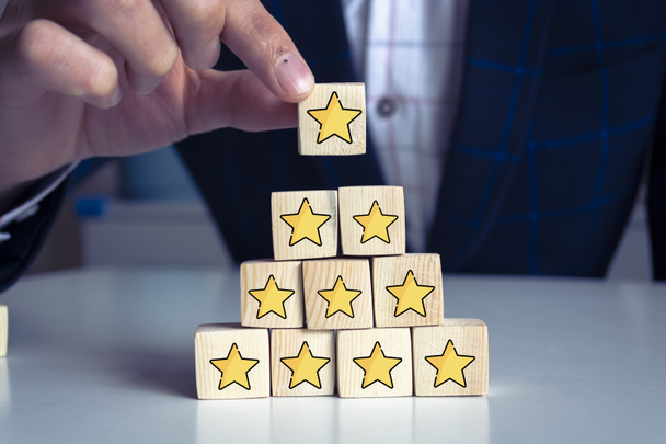 Business service rating , Satisfaction concept. Hand arranging symbol with star icon on wood cube block for rate up. best support or take care. - Photo, Image