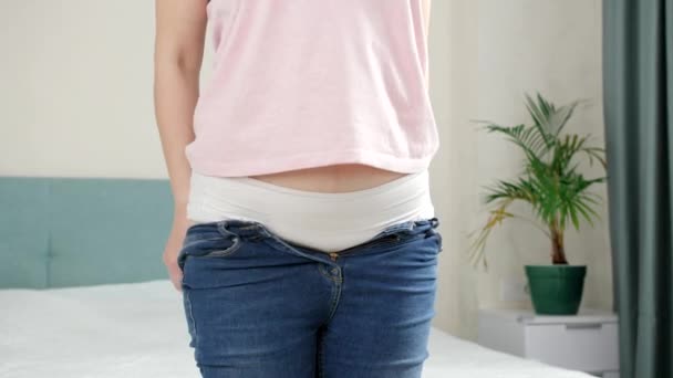 Success in fitting and dressing in tight jeans. Concept of excessive weight, obese female, dieting and overweight problems - Footage, Video