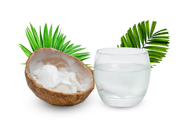 Coconut juice in glass cup with green leaves pattern isolated on white background - Foto, imagen