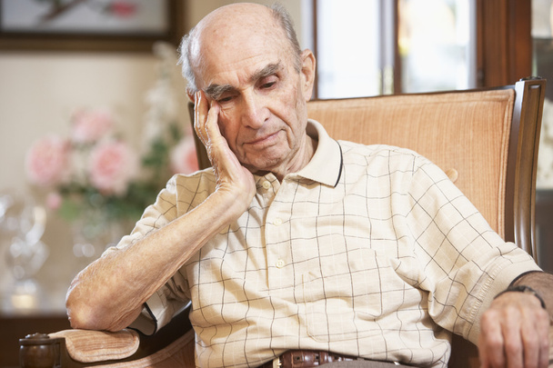 Senior man resting in armchair - Фото, изображение