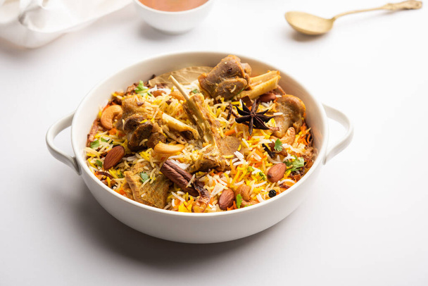 Indian Mutton biryani prepared in Basmati Rice served with Yogurt dip over moody background, Selective focus - Φωτογραφία, εικόνα