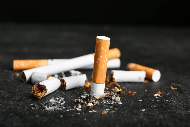 Many cigarettes on dark background - Photo, Image