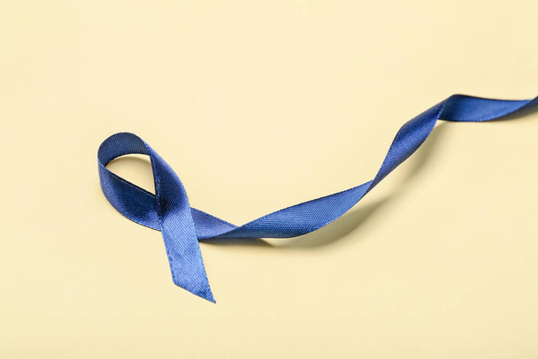 Blue ribbon on color background. Colon cancer concept - Foto, Bild