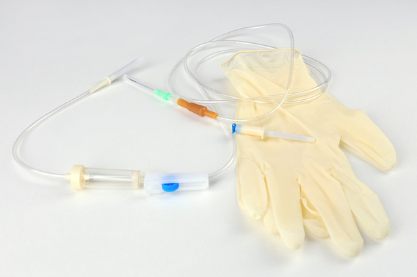 Disposable infusion set on grey background - Foto, Imagen