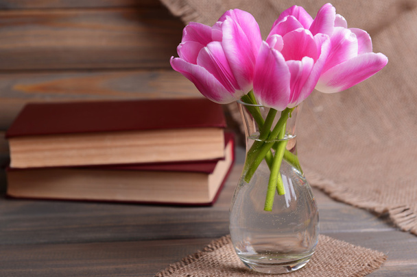 Beautiful tulips in bucket in vase on table on grey background - Foto, immagini
