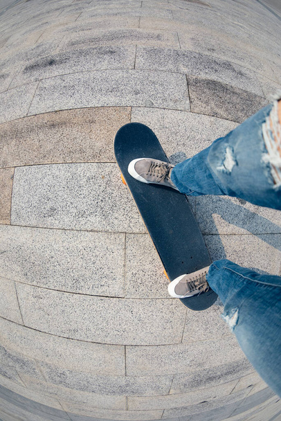 Skateboarder legs skateboarding at outdoors - Valokuva, kuva