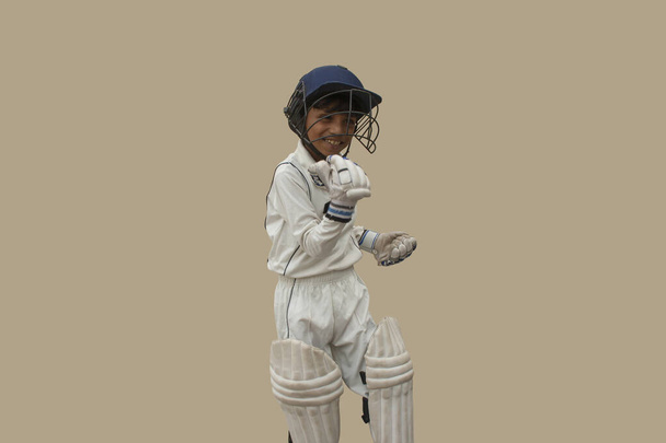 Niño en uniforme de cricket Un victorioso de pie en frente - Foto, imagen