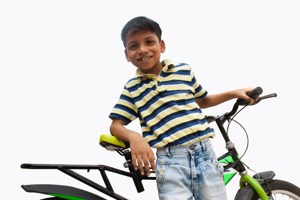 Portrait of confident boy With bicycle - Photo, Image