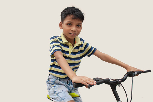 Portrait of confident boy sitting on bicycle - Photo, Image