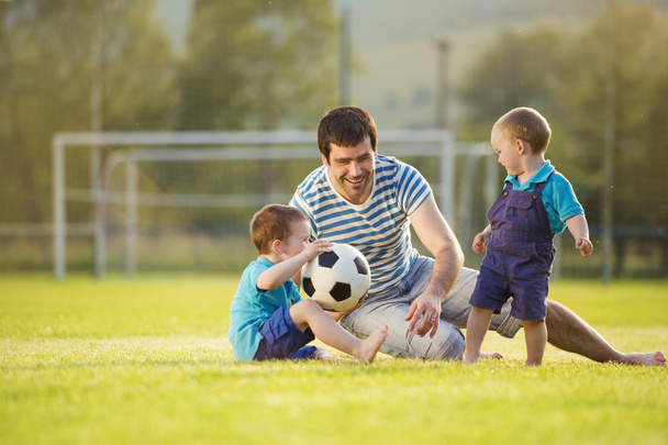Father with sons playing football - Photo, image