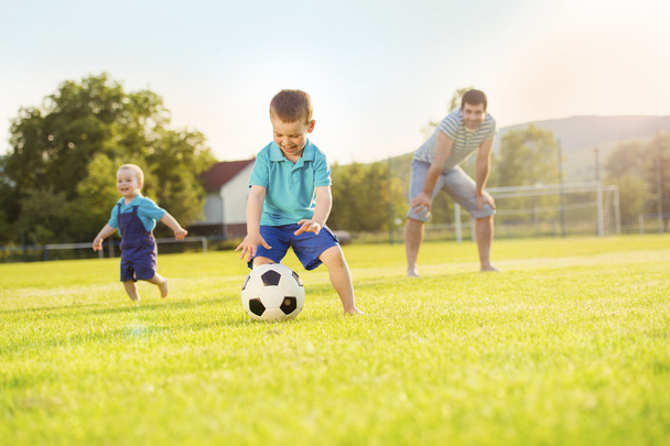Father with sons playing football - Φωτογραφία, εικόνα