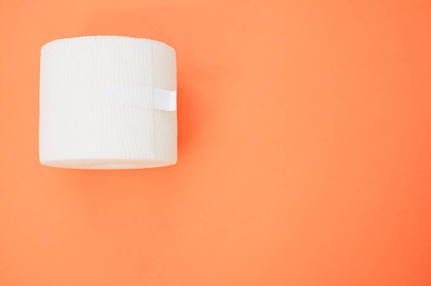 a top view of a sterile gauze bandage roll isolated on a co background on the left side - Foto, immagini