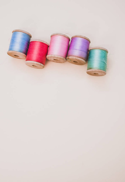 A colorful sewing threads on a light background with free space for text - Valokuva, kuva