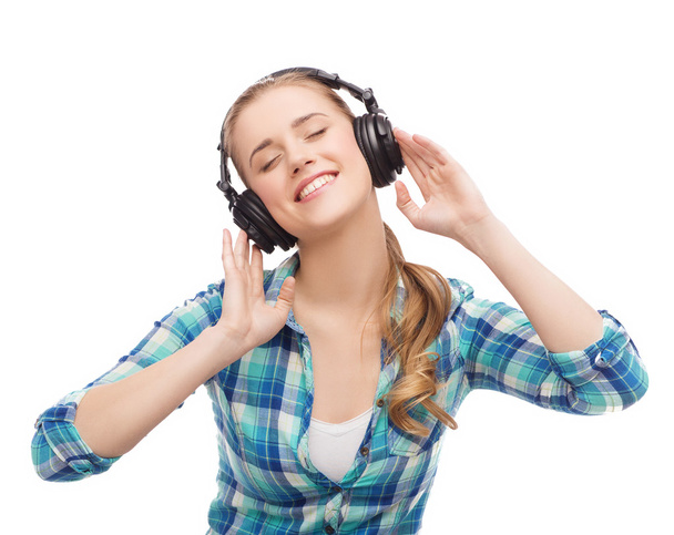 young woman listening to music in headphones - Foto, Imagem