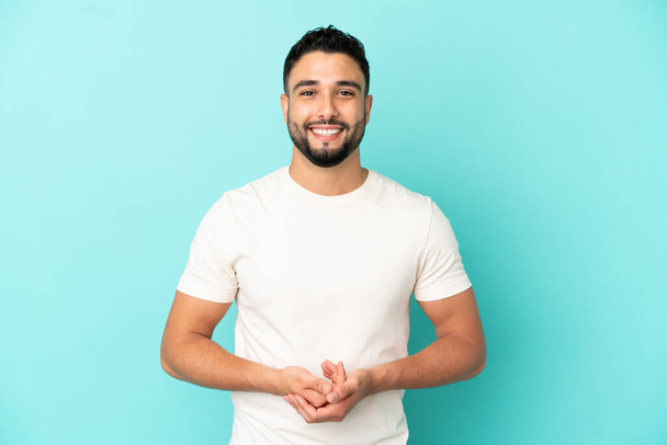 Young arab man isolated on blue background laughing - Foto, afbeelding