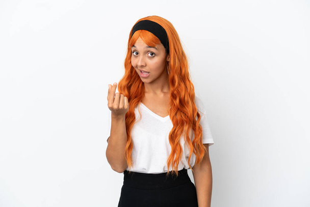 Young woman with orange hair isolated on white background making money gesture - Photo, Image