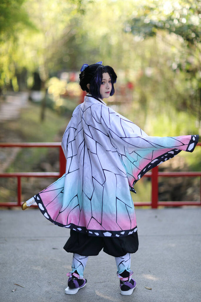 Japan anime cosplay portrait of girl with comic costume with japanese theme garden - Foto, afbeelding