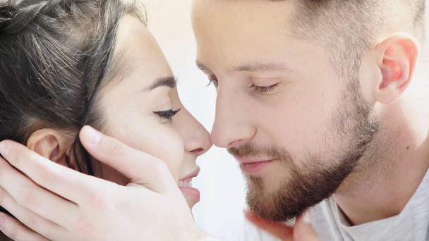 close up of caring man touching face of smiling girlfriend at home - Photo, Image