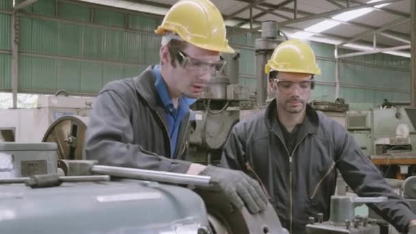 Engineer man training with foreman for apprentice using lathe, apprenticeship teaching with worker, technician and learning, inspector and labor, internship and workshop, industrial concept. - Footage, Video