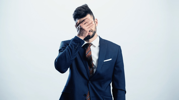 depressed businessman covering eyes with hand isolated on white - Photo, Image