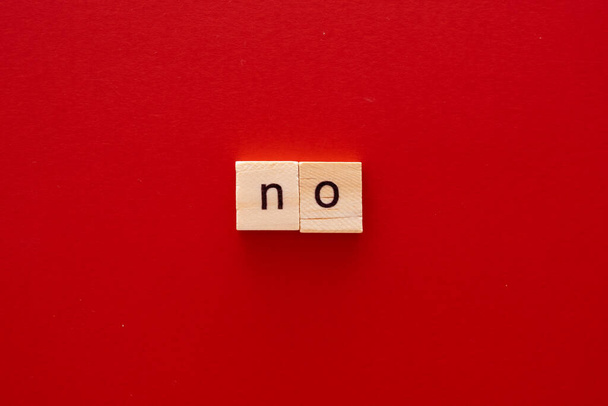 word NO made of wooden letters on red background with copy space - Foto, Imagen