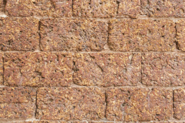 desenfoque de la pared de ladrillo de laterita roja Patrón de fondo poroso y de grano fino, parttern blackground sin costuras - Foto, Imagen
