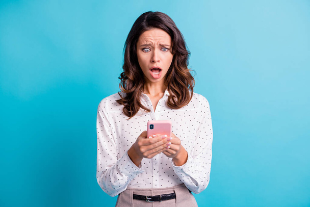 Portrait of impressed sad brunette girl yell look telephone wear shirt isolated on teal color background - Φωτογραφία, εικόνα