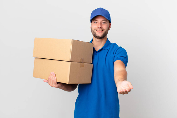 package deliver man smiling happily with friendly and  offering and showing a concept - Foto, Bild