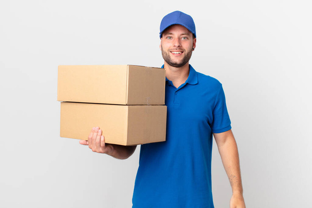 package deliver man looking happy and pleasantly surprised - Zdjęcie, obraz