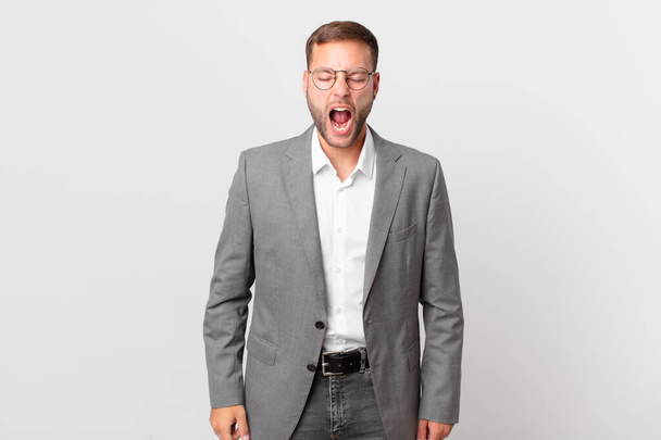 handsome businessman shouting aggressively, looking very angry - Fotoğraf, Görsel