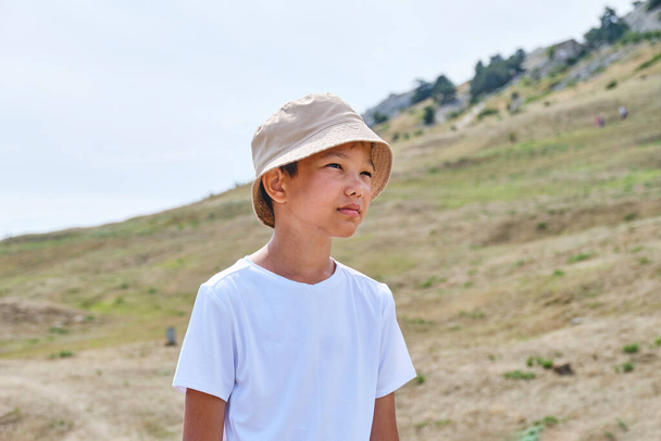 Portrait of an Asian boy in a white T-shirt and a panama hat - Photo, Image