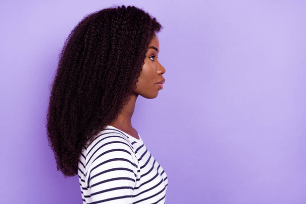 Profile photo of confident young lady look empty space wear striped sweater isolated on violet color background - Fotoğraf, Görsel