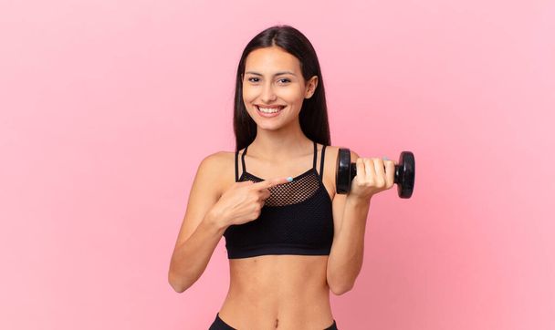 hispanic pretty woman with a dumbbell. fitness concept - Fotoğraf, Görsel