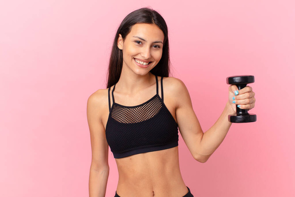 hispanic pretty woman with a dumbbell. fitness concept - Фото, зображення