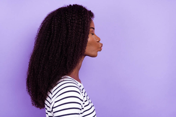 Profile side view portrait of attractive dreamy amorous girl sending air kiss copy space isolated over violet purple color background - Photo, Image