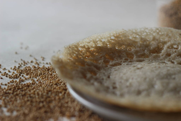 発酵させたコドアワのホッパーには、コドアワの打者、平らな米、酵母で発酵させたココナッツが用意されています。見て、味は米のホッパーと同じですが、非常に栄養価の高い. - 写真・画像