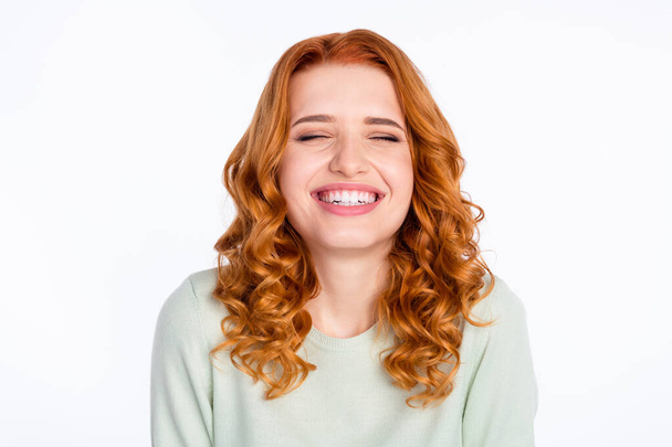 Photo portrait of red haired young girl laughing wearing green sweater isolated on white color background - Foto, Bild