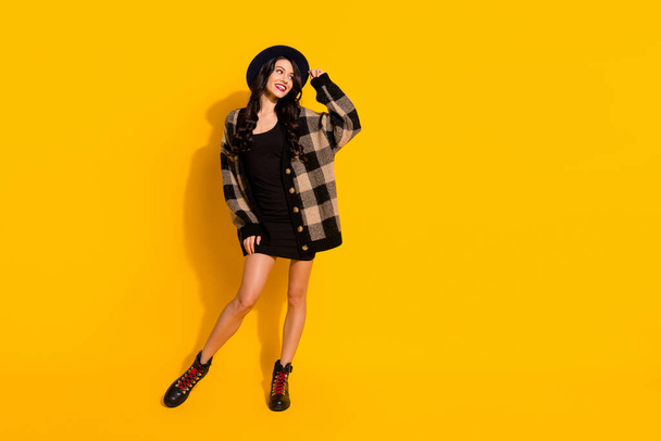 Photo of dreamy lady look empty space wear hat plaid coat mini dress footwear isolated yellow color background - 写真・画像