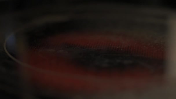 Lassú mozgású vízcseppek egy vörös forró felületen, ami gőzt okoz - Felvétel, videó