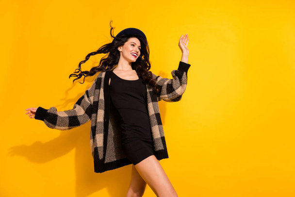 Photo of inspired dreamy lady look empty space wear black headwear plaid coat isolated yellow color background - Φωτογραφία, εικόνα