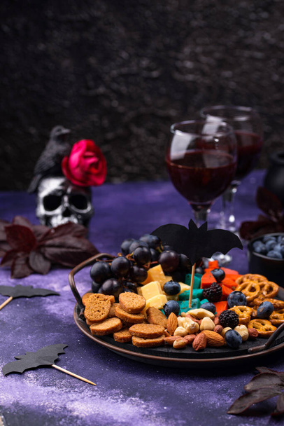 Halloween appetizers. Cheese plate with snacks - Photo, Image